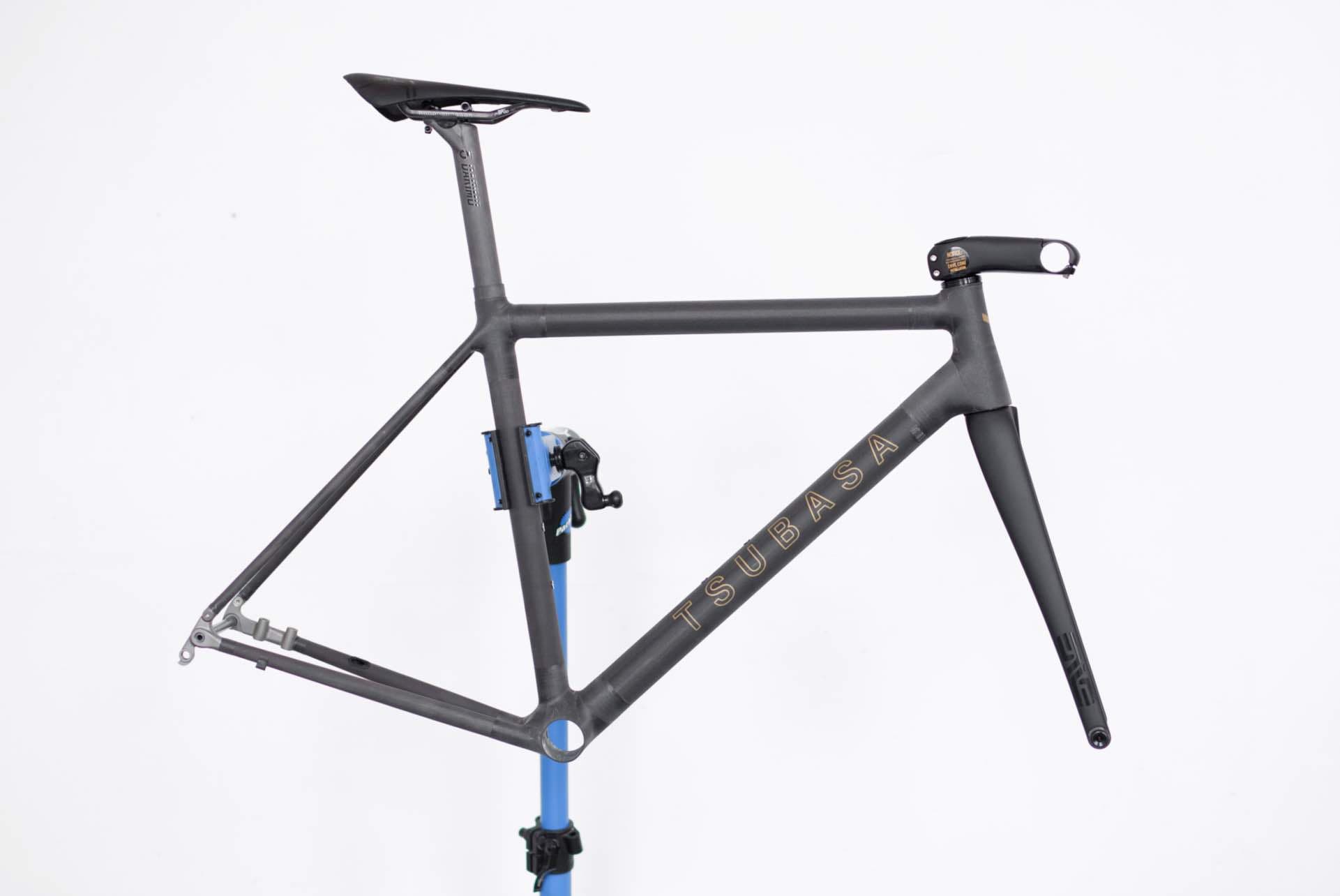 The Crow's head tube and fork crown, close, showing the raw carbon weave