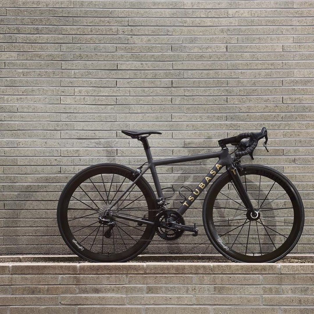 A bike standing at the foot of a long flight of concrete steps