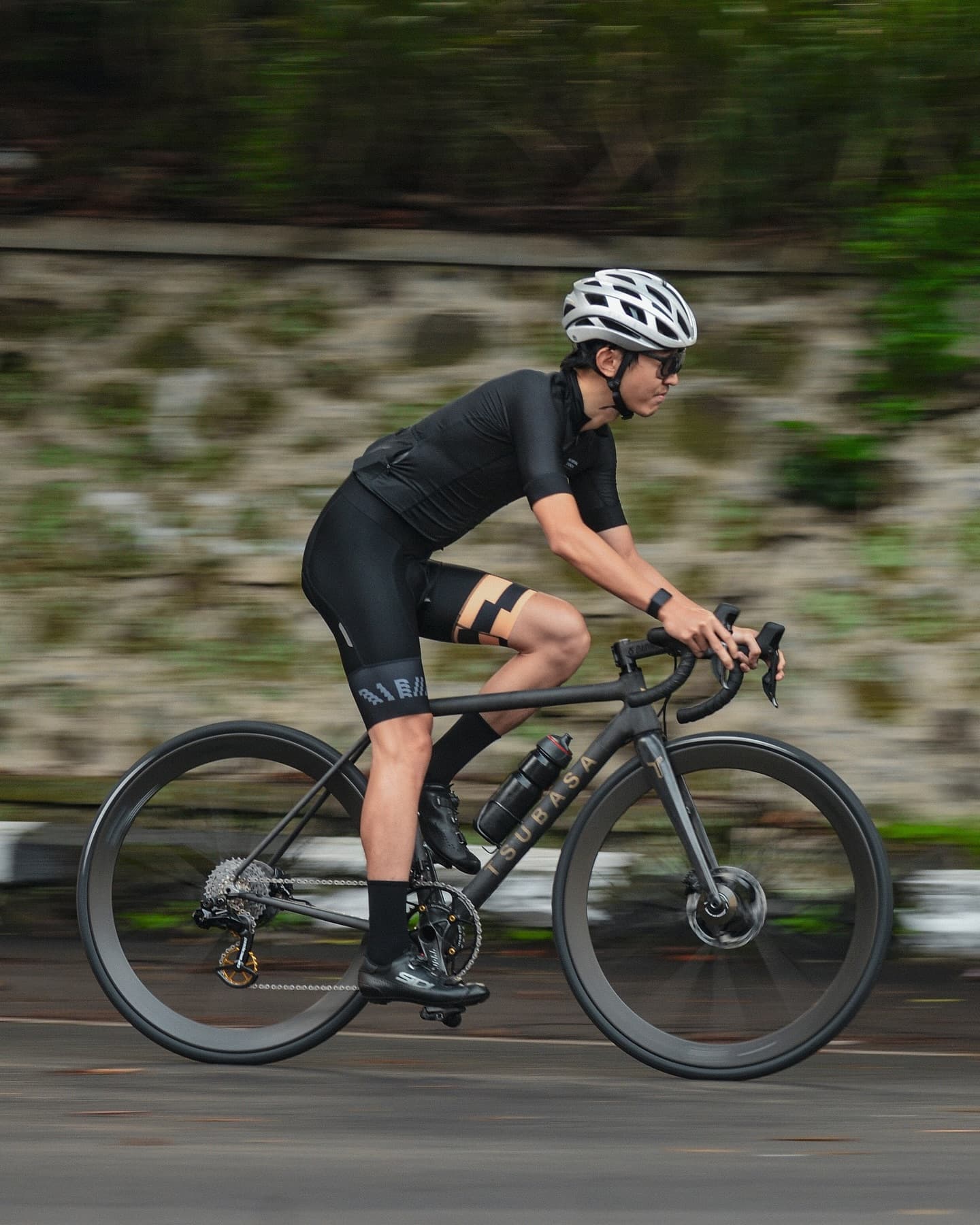 A rider panning past a stone wall, the background pulled to a blur